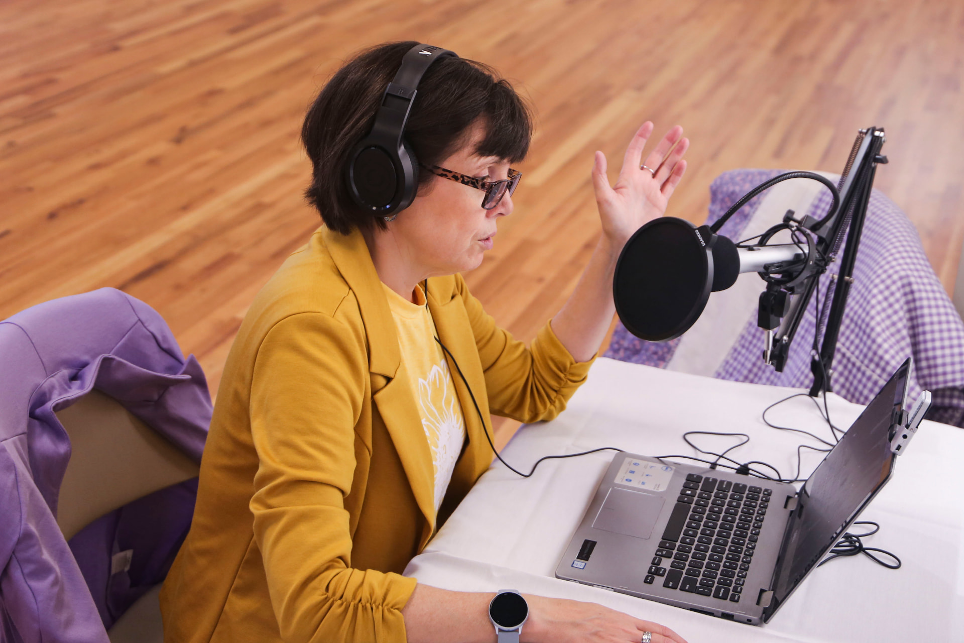 Dr. Tracie Edwards at the microphone during a podcast session